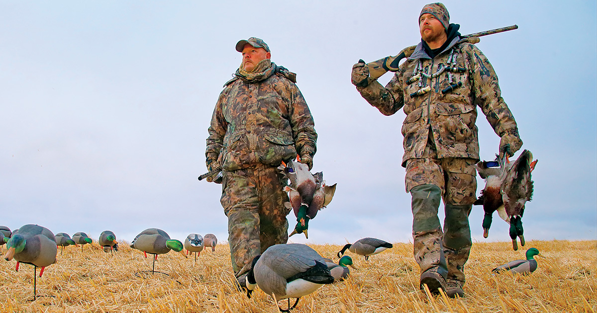 Waterfowl hunters in the decoys with harvested waterfowl. Photo by GaryKramer.net